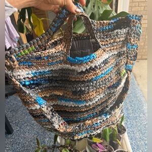 Handmade from plastic bags crocheted shopping tote bag with a pocket